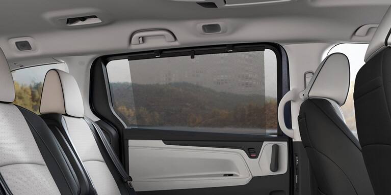 2027 Honda Odyssey Elite rear passenger seats featuring an integrated window sunshade (Minivan).